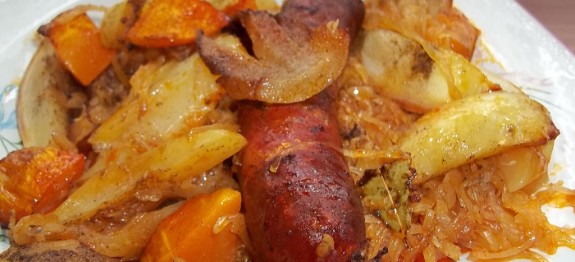 Sült kolbász és szalonna fehérboros káposztaágyon, krumplival és sütőtökkel